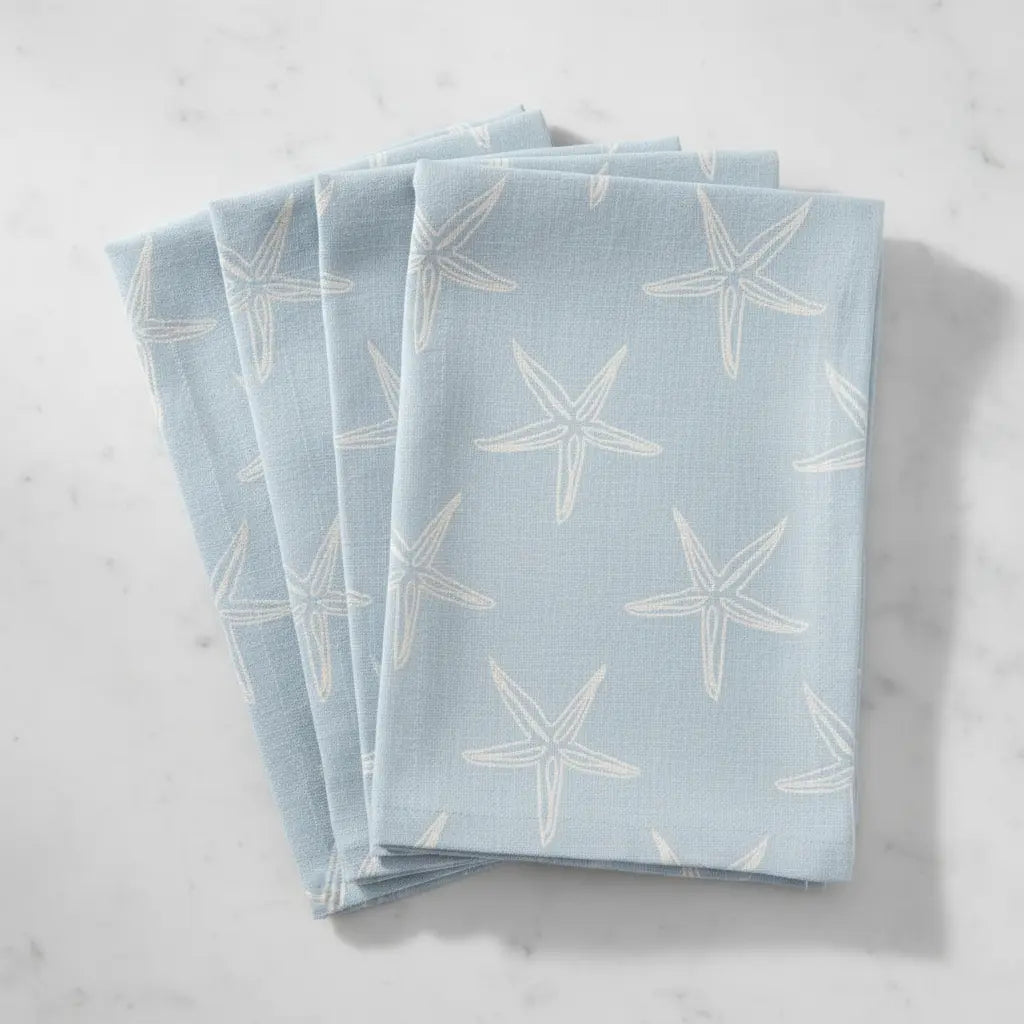 Nantucket Starfish Napkins in seafoam blue, set of 4 with delicate white starfish silhouettes.