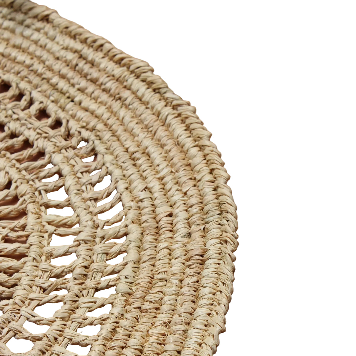 Coastal tan woven placemats styled on a bright dining table.