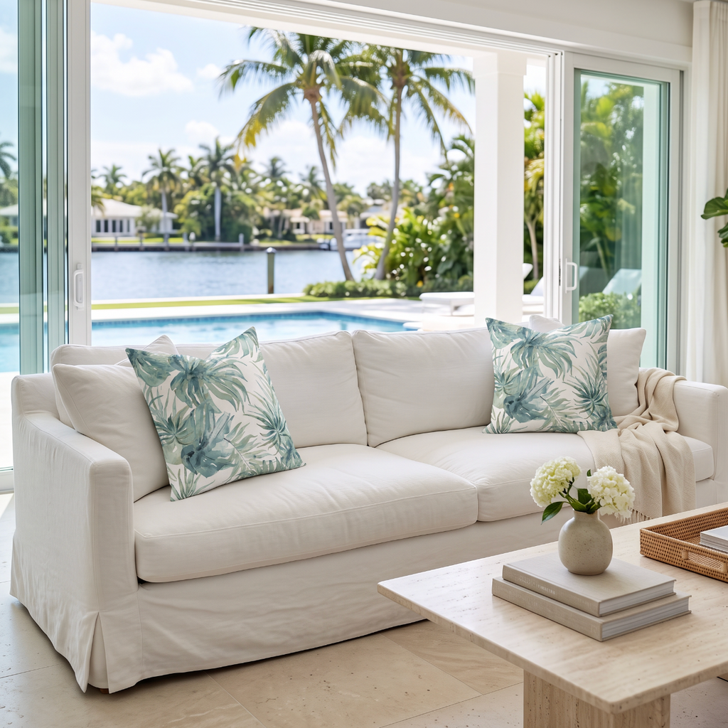 Decorative throw pillow with a watercolor palm pattern for modern coastal and tropical interiors