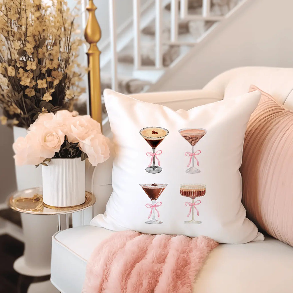 Coquette Espresso Martini Throw Pillow, a white square cushion with four illustrated cocktails tied with pink bows.