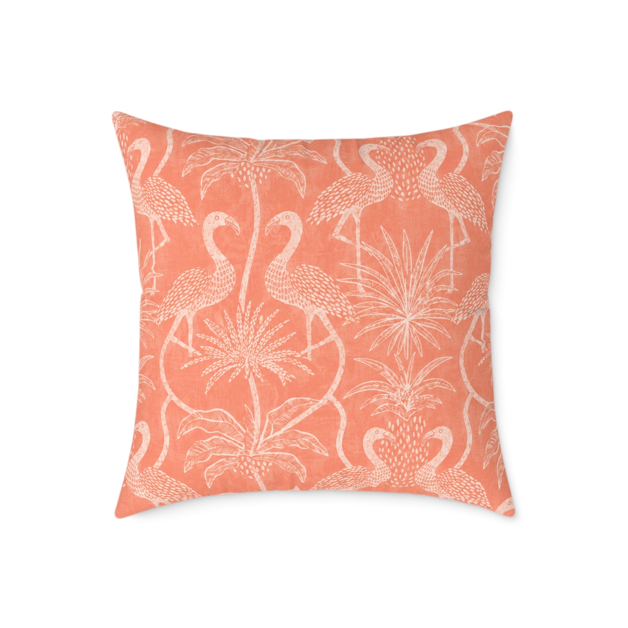 Pink tropical bird pillow bringing cheerful resort style to rattan furniture and neutral upholstery.