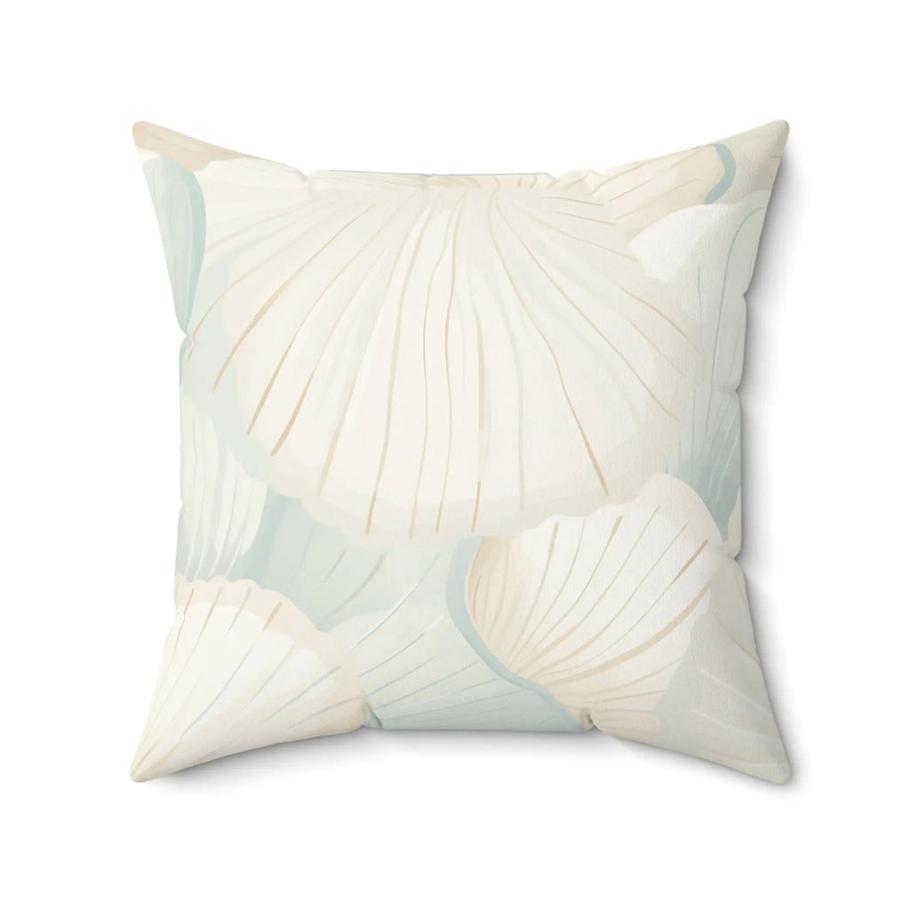 Closeup of cream seafoam shell pattern pillow showing seashell design.