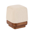 Cream textured ottoman with a wood base in a coastal-inspired home