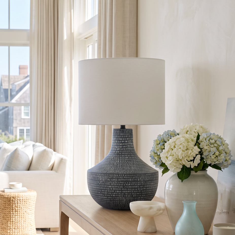 dark blue ceramic table lamp with a small white dash pattern and a large white drum shade.