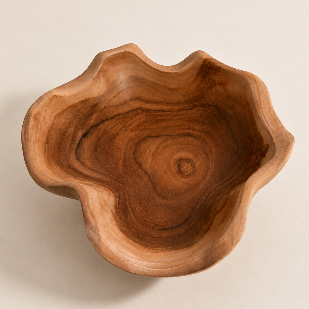 Decorative teak wood bowl featuring a sculptural wavy shape for tabletop styling.