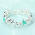 Coastal wave link starfish and shell stretch bracelet photographed in a flatlay with seashells