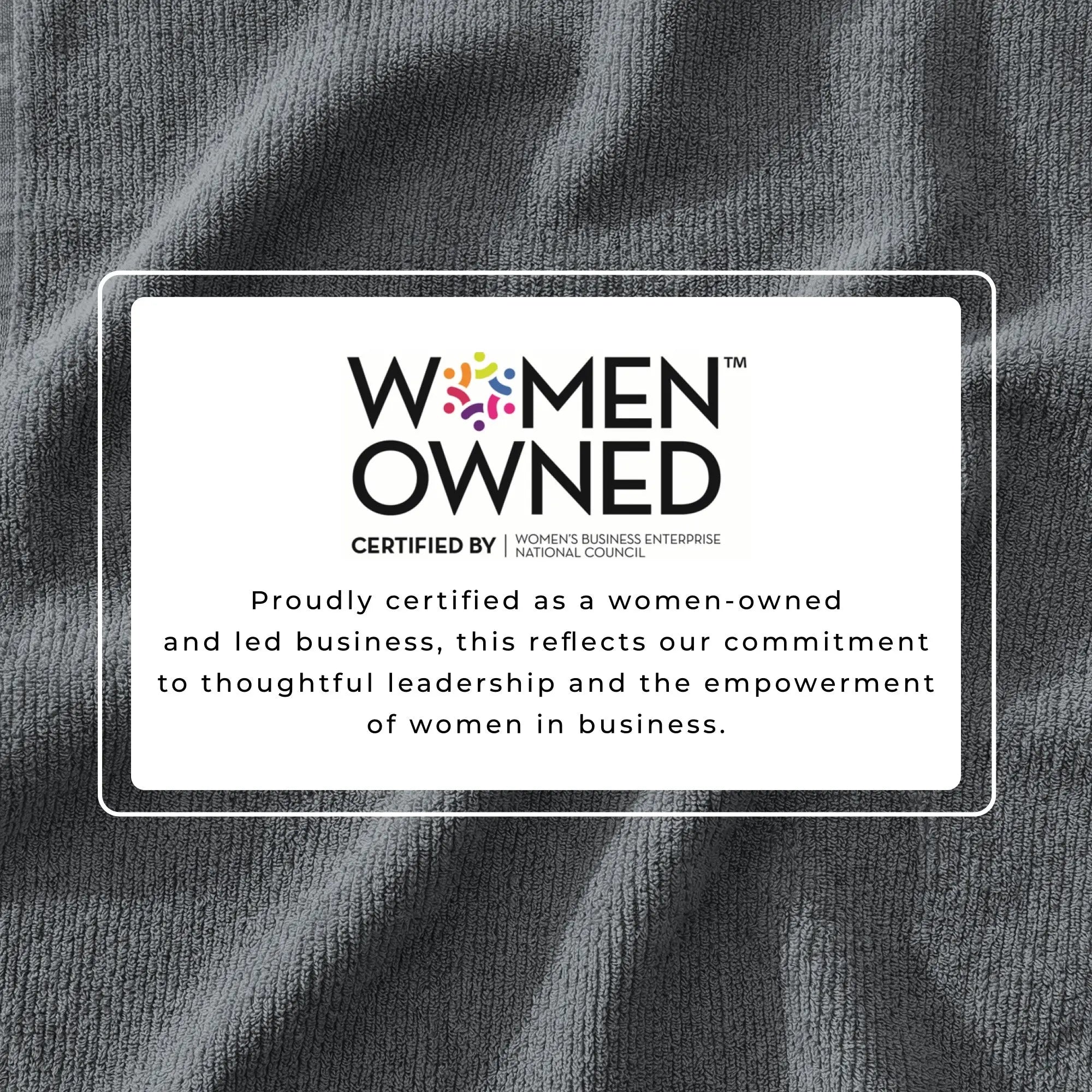 Bath towel set with Women Owned certification badge on grey ribbed fabric