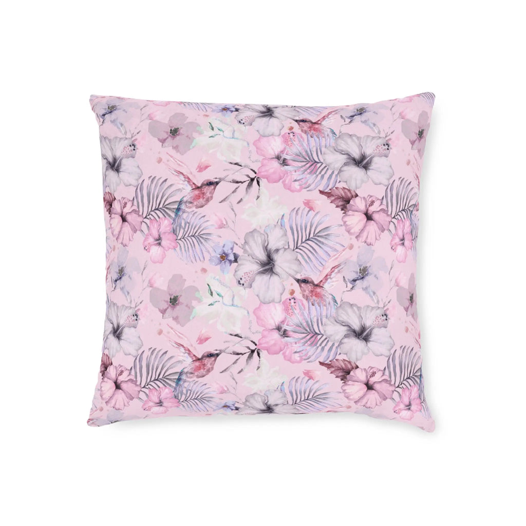 Pink floral throw pillow with hummingbirds and tropical flowers in soft pastel tones.