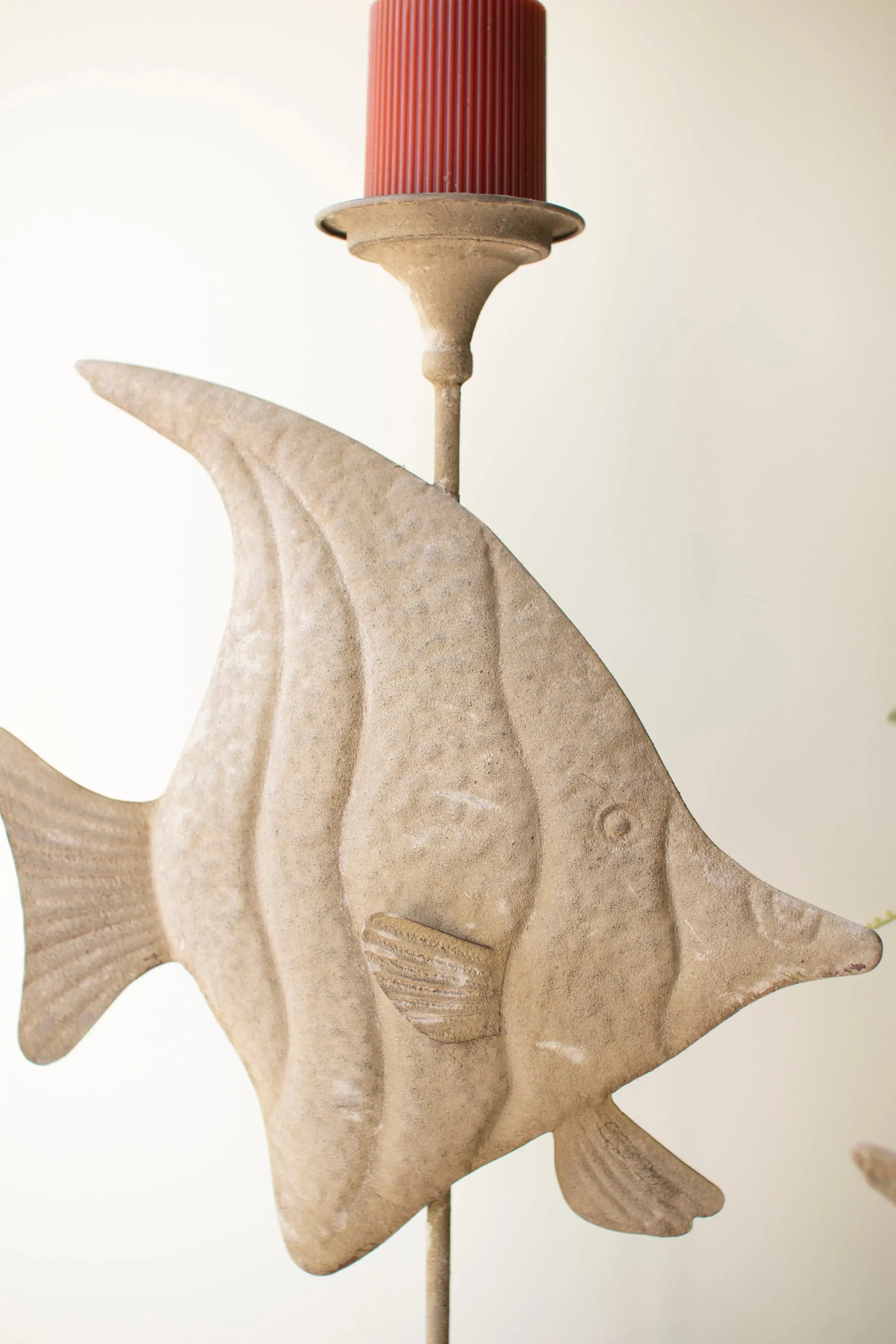 Set of two fish-shaped candle holders used as a beach house centerpiece