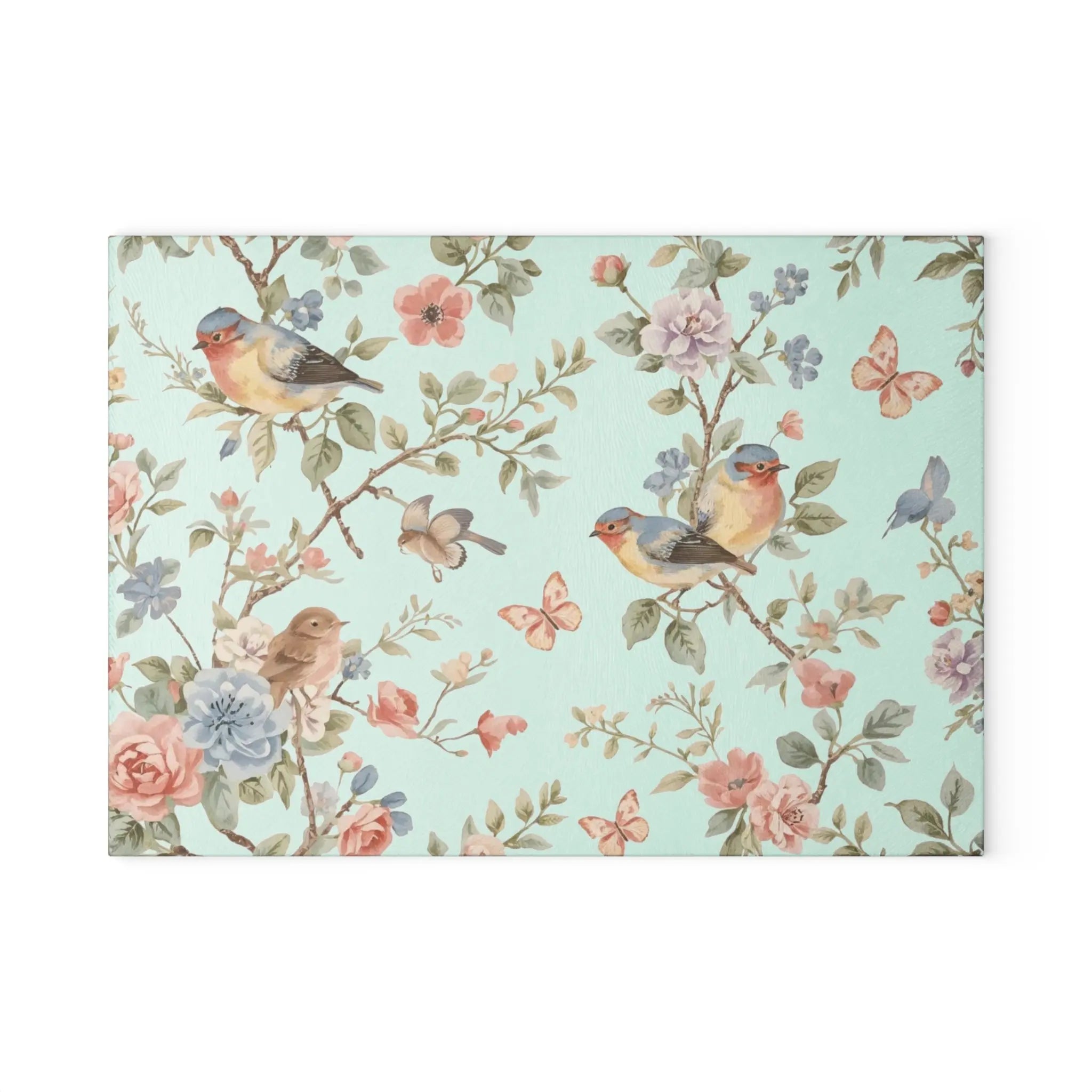 Meadow Glass Cutting Board with pastel floral pattern, songbirds on branches among blossoms and butterflies.