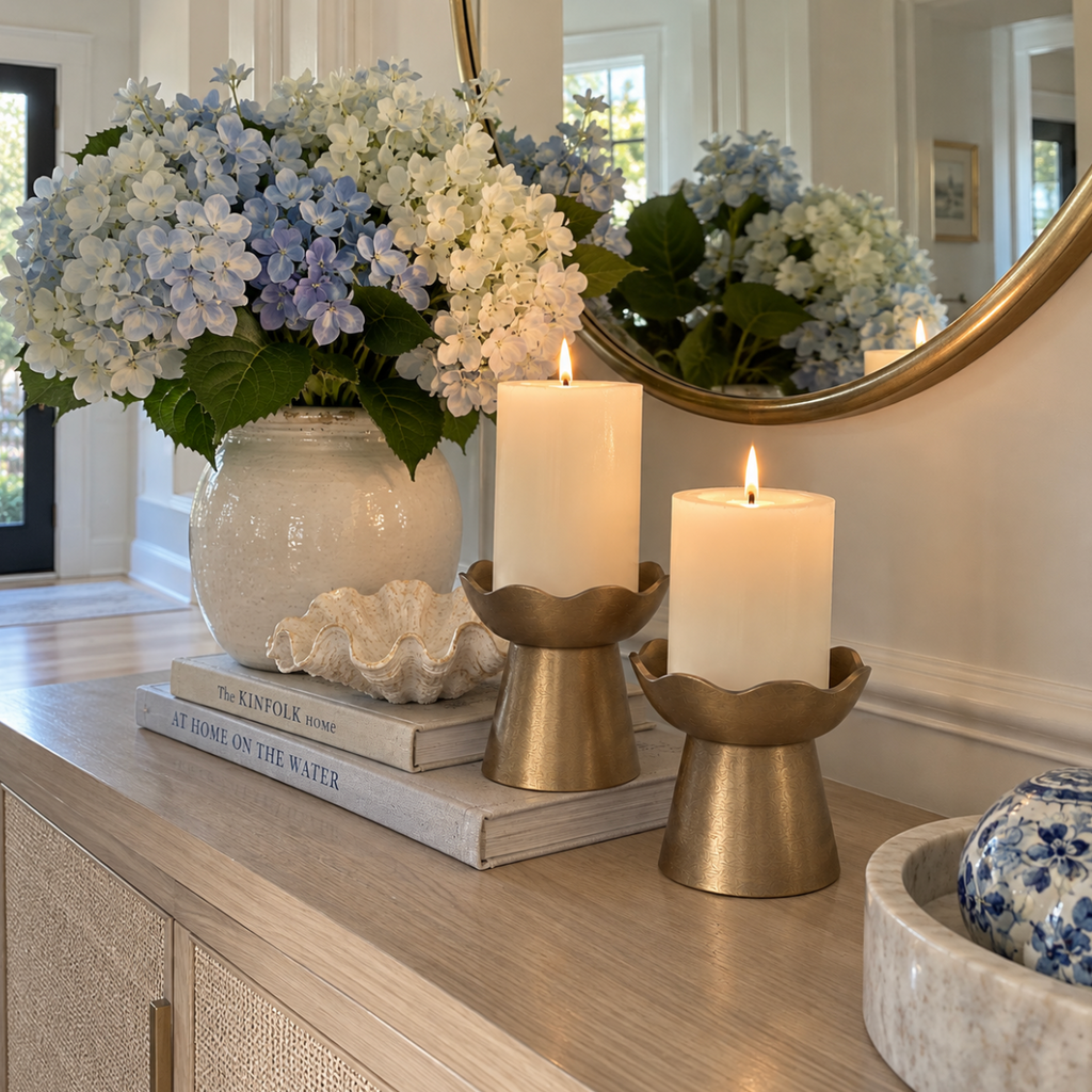 Gold metal candle holder set with a modern sculptural design.