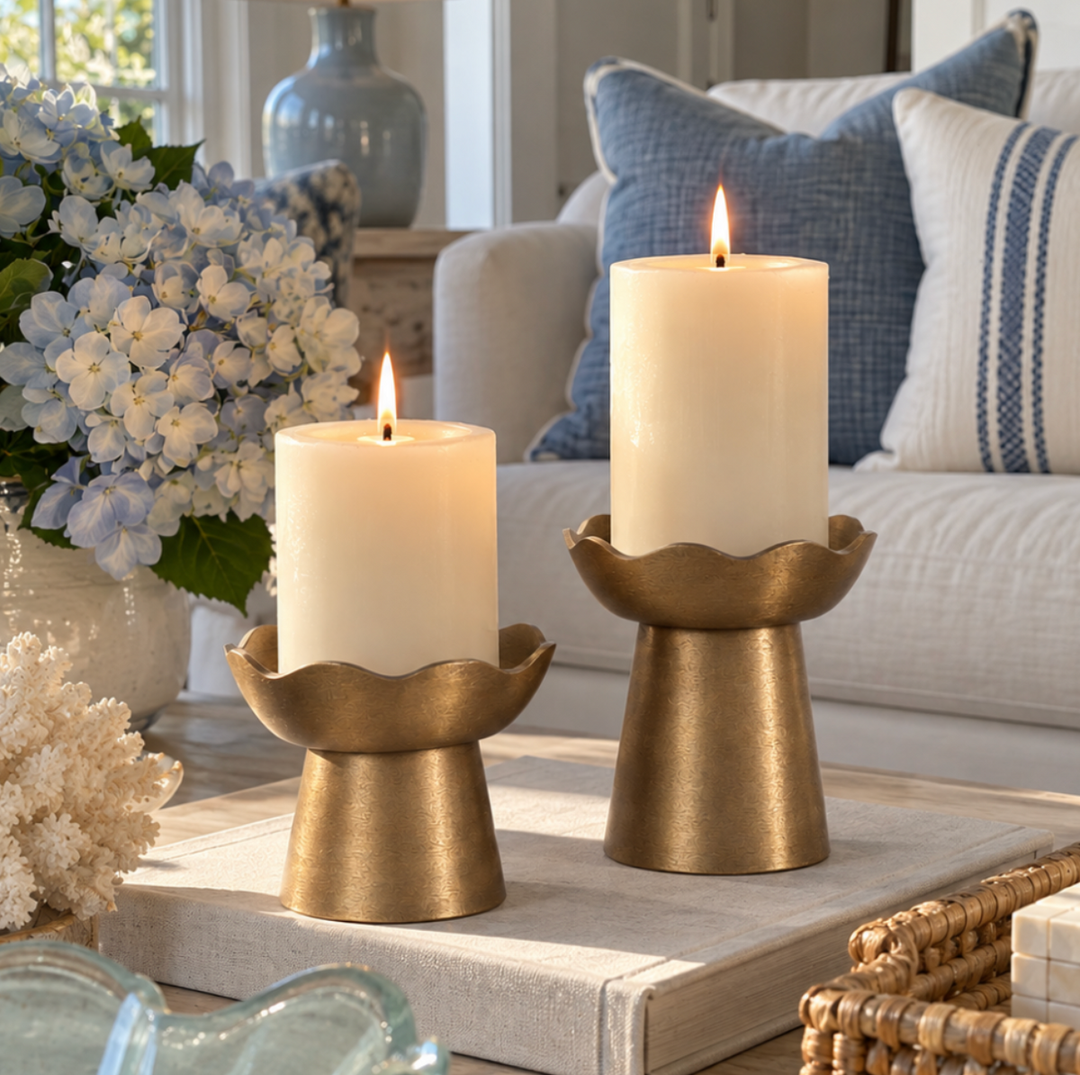 Gold metal pillar candle holder set with graduated heights.