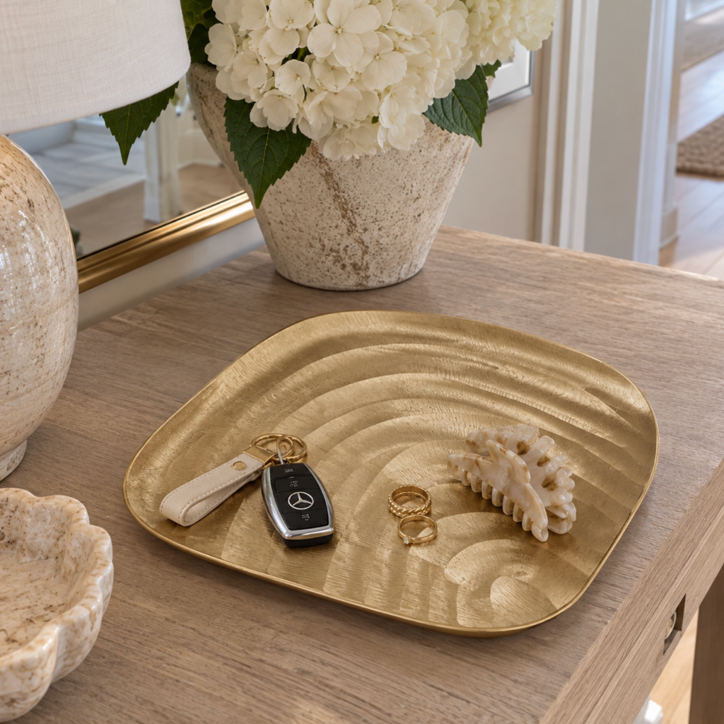 Gold seashell decorative tray for displaying jewelry and small accessories.