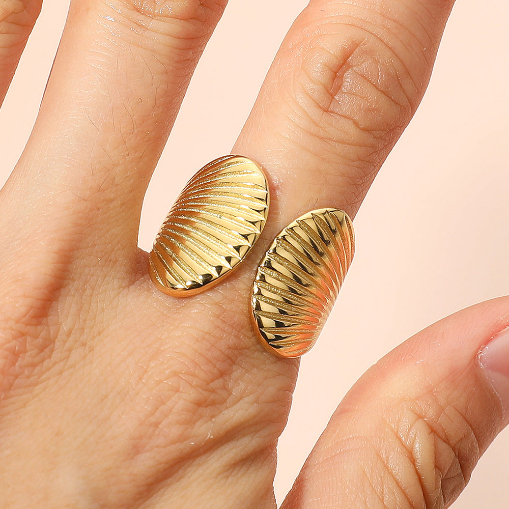 Gold stainless steel seashell adjustable ring shown as beach inspired everyday jewelry.