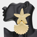Gold starfish statement dangle earrings displayed as beach vacation jewelry
