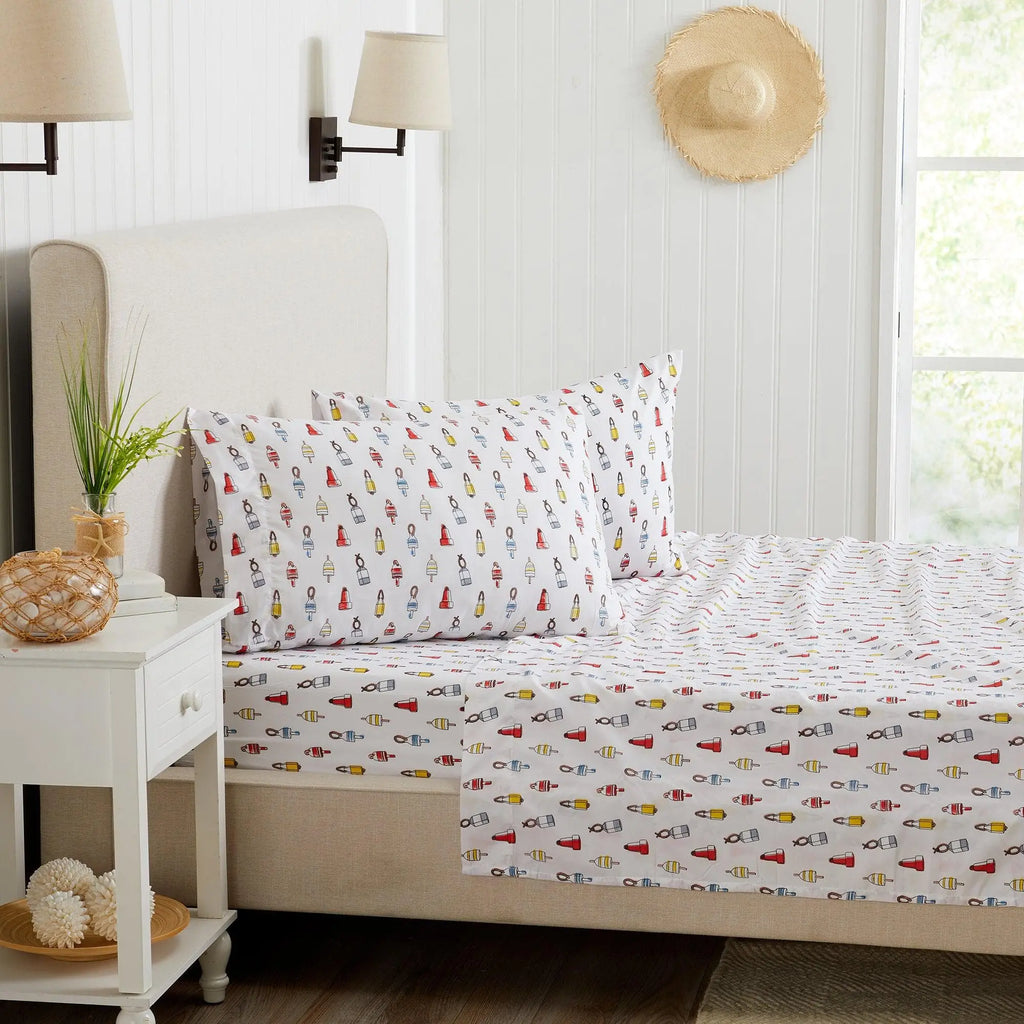 Coastal Sheet Set Nantucket Collection by Great Bay Home; white sheets with a colorful nautical print.