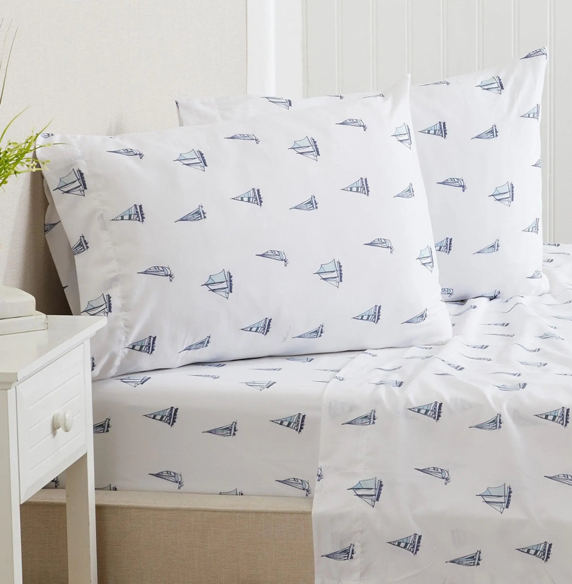 Coastal Sheet Set - Nantucket Collection by Great Bay Home; white fabric with blue sailboat print, two pillows on bed.
