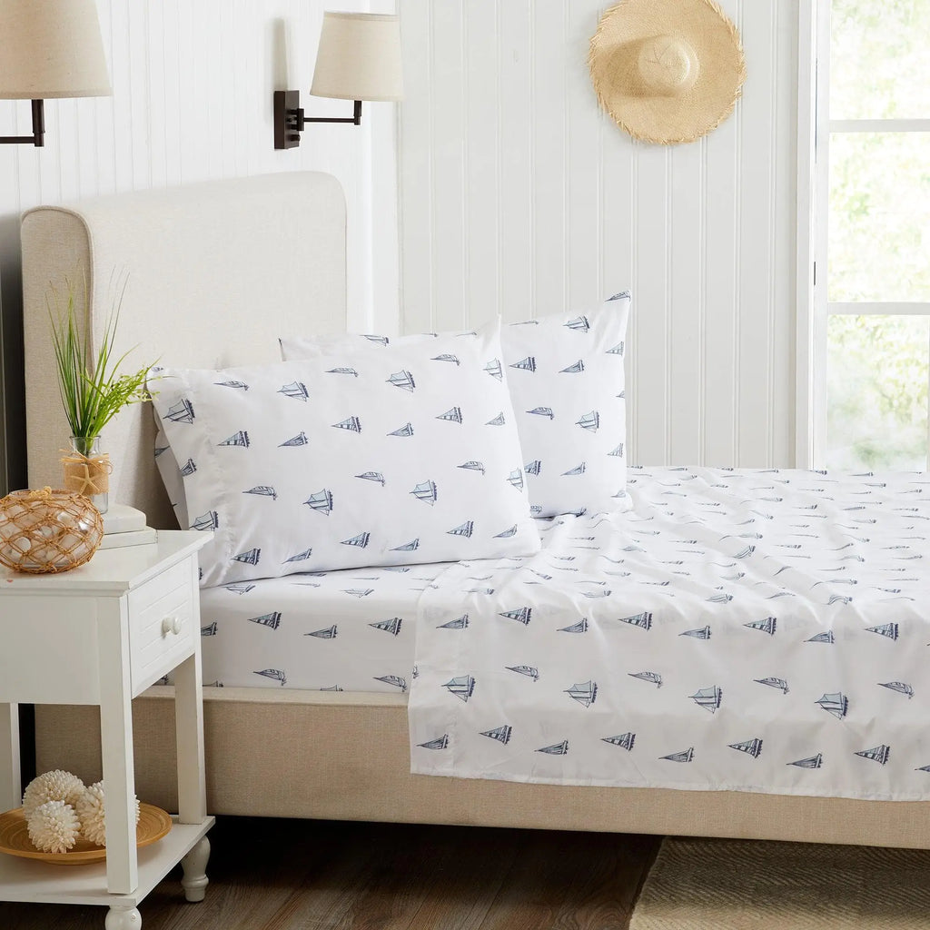 Great Bay Home Coastal Sheet Set, Nantucket Collection; white sheets with navy sailboat print, 2 pillowcases on bed