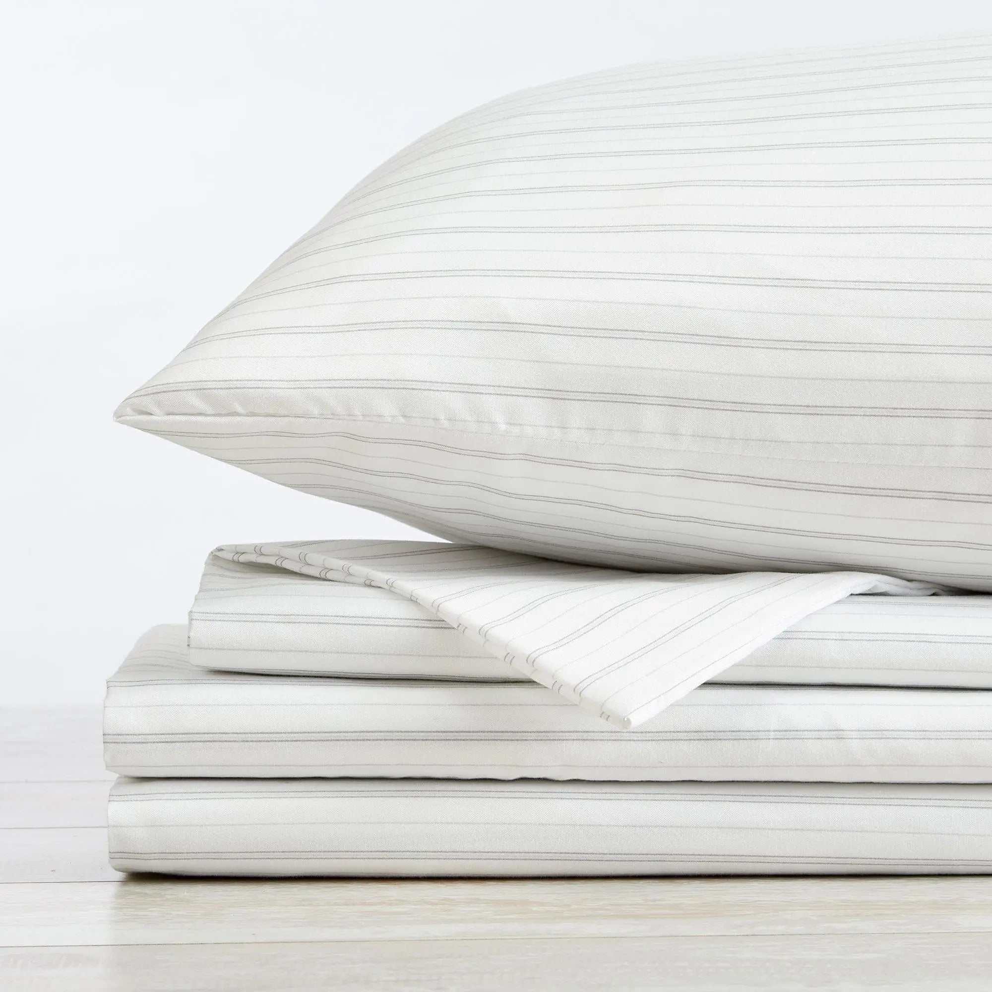 Stripe Sheet Set - Adeline Collection by Great Bay Home, white with thin gray stripes, folded on a stack.