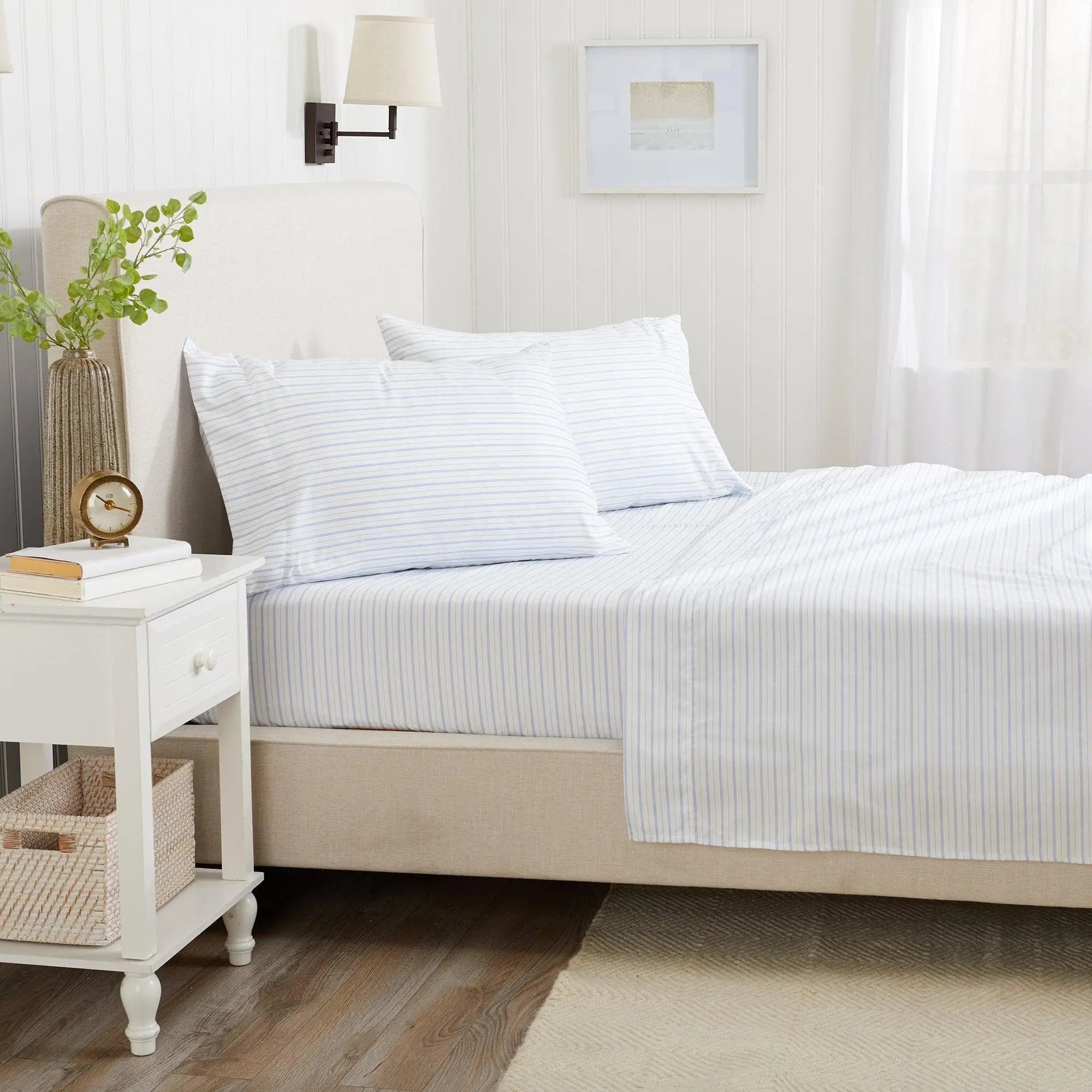 Stripe Sheet Set by Great Bay Home Adeline Collection on a light bed with blue striped sheets and matching pillowcases