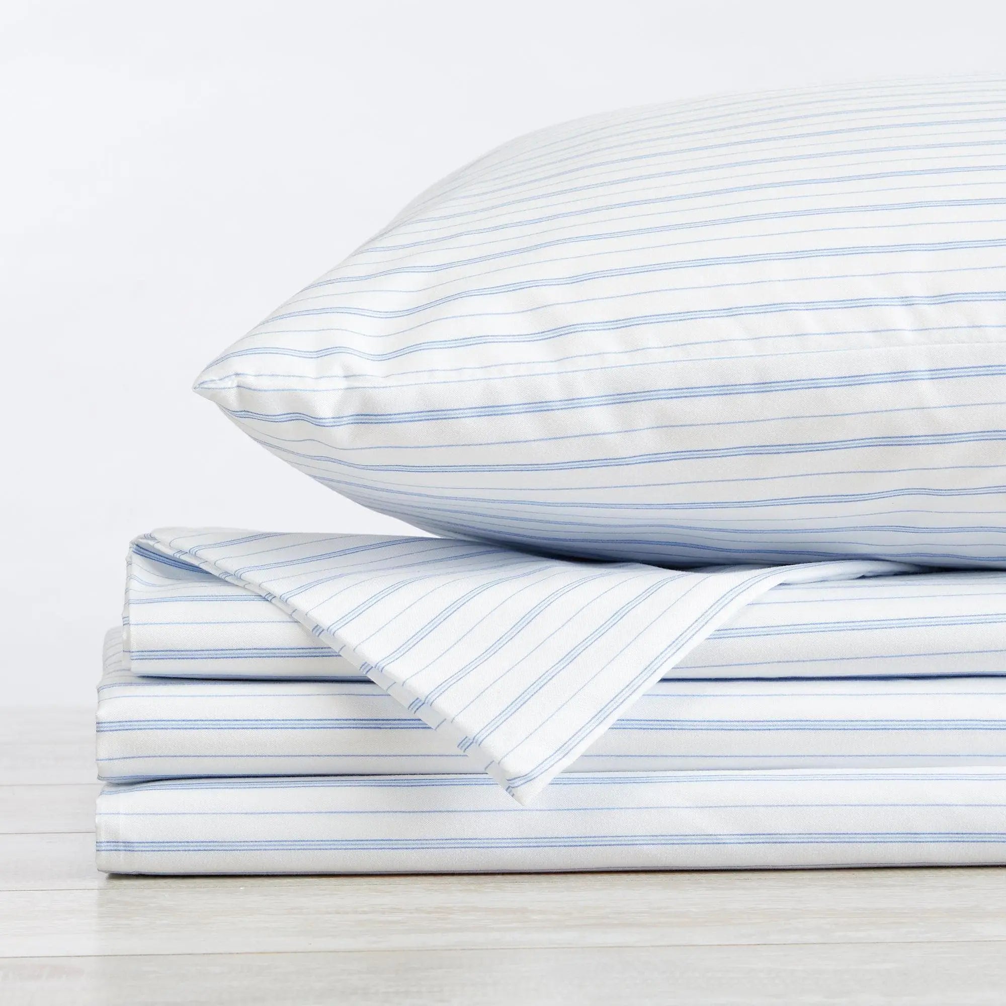 Stripe Sheet Set - Adeline Collection, light blue striped bed sheets folded with a pillow on top