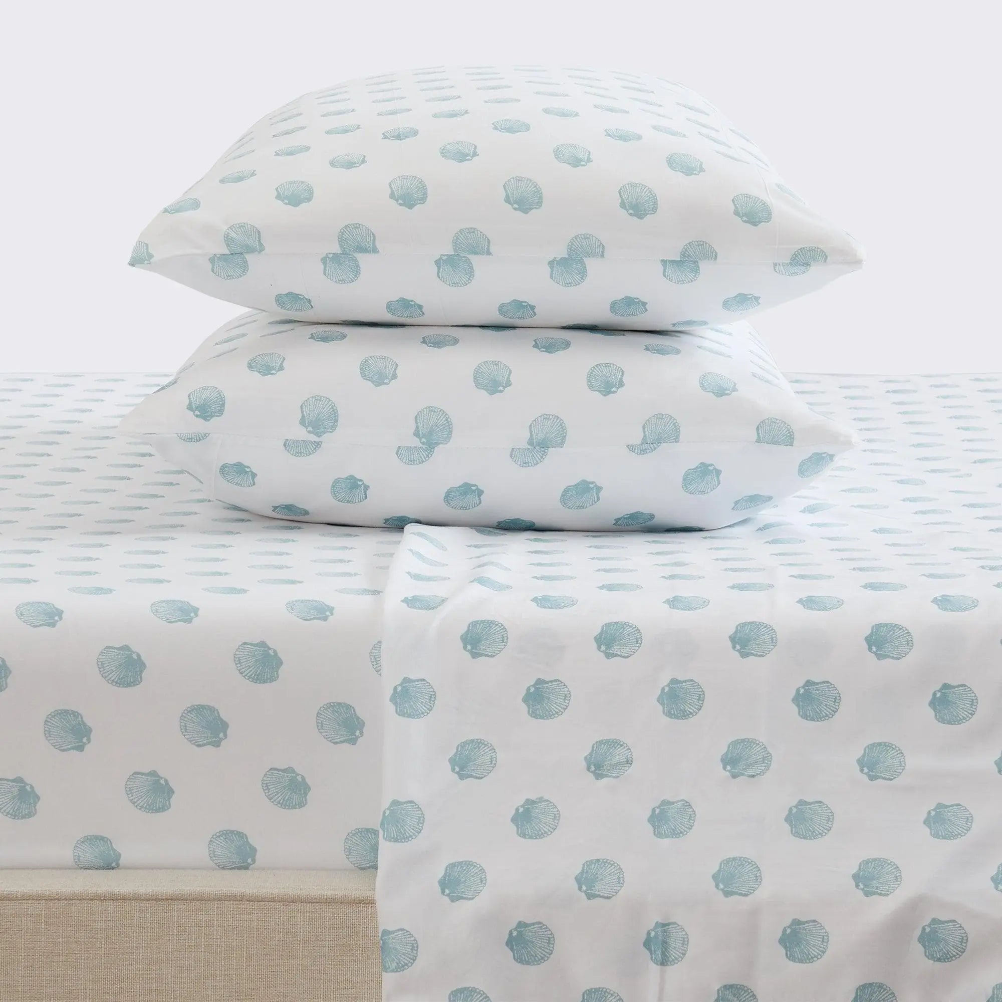 Coastal sheet set by Great Bay Home; Nantucket collection, white with light blue seashell pattern, two pillows shown.