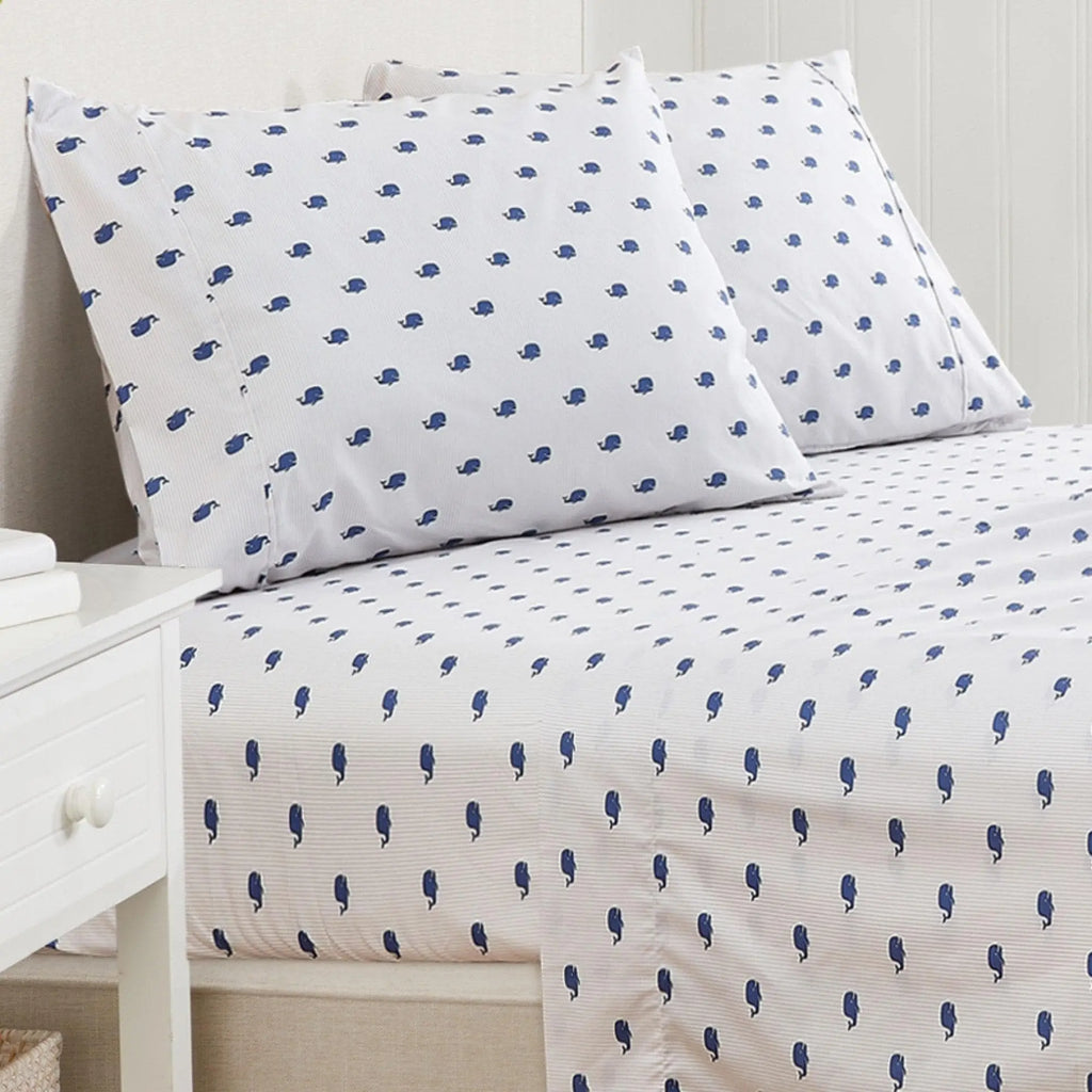 Coastal bed sheet set, Nantucket Collection, with two white pillows featuring blue whale silhouettes.