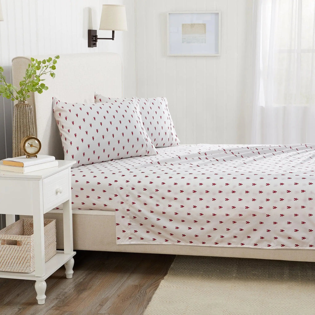 Coastal Sheet Set - Nantucket Collection by Great Bay Home on a white bed with a small red nautical pattern.