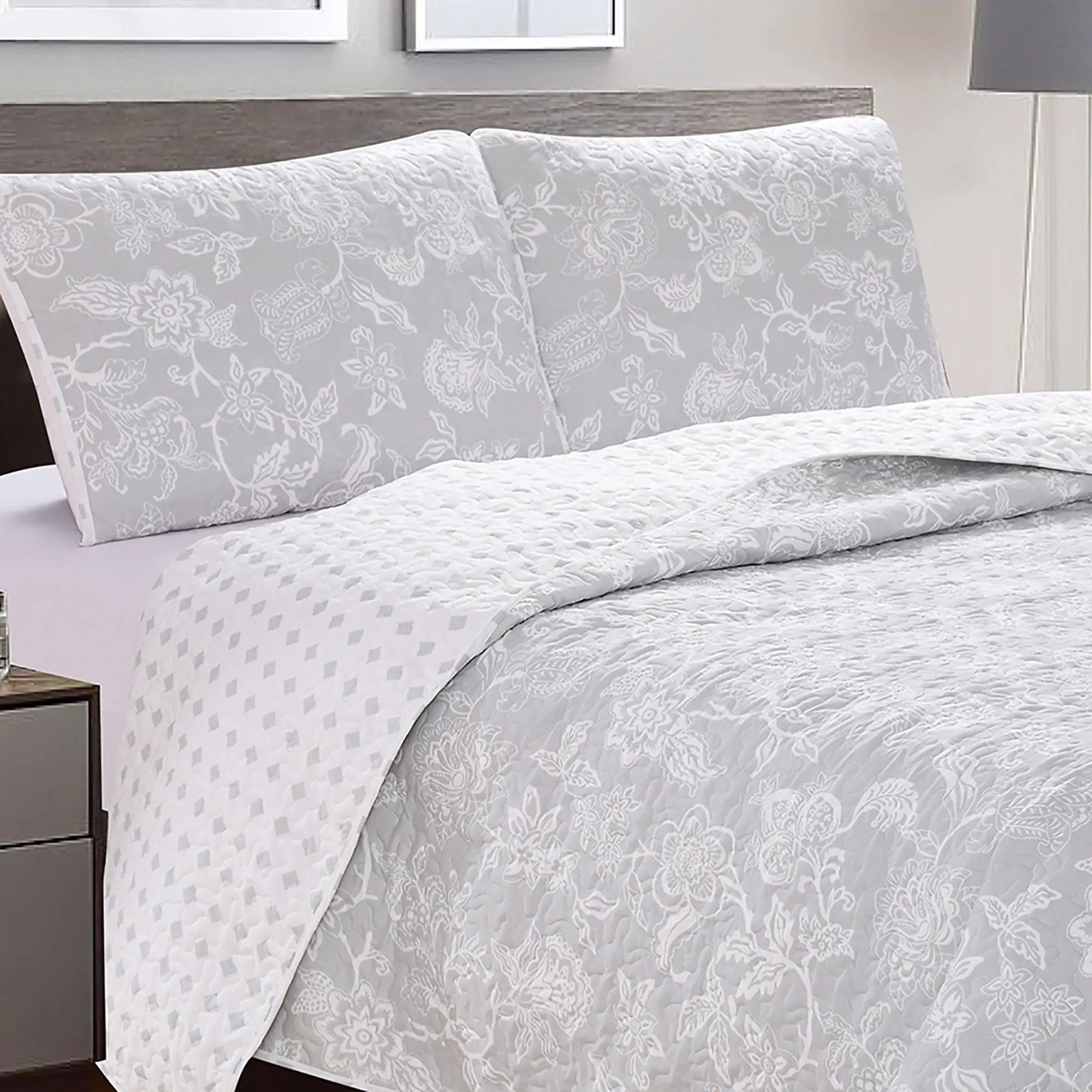 Floral Quilt Emma Collection by Great Bay Home; light gray with white floral pattern, includes two matching shams.