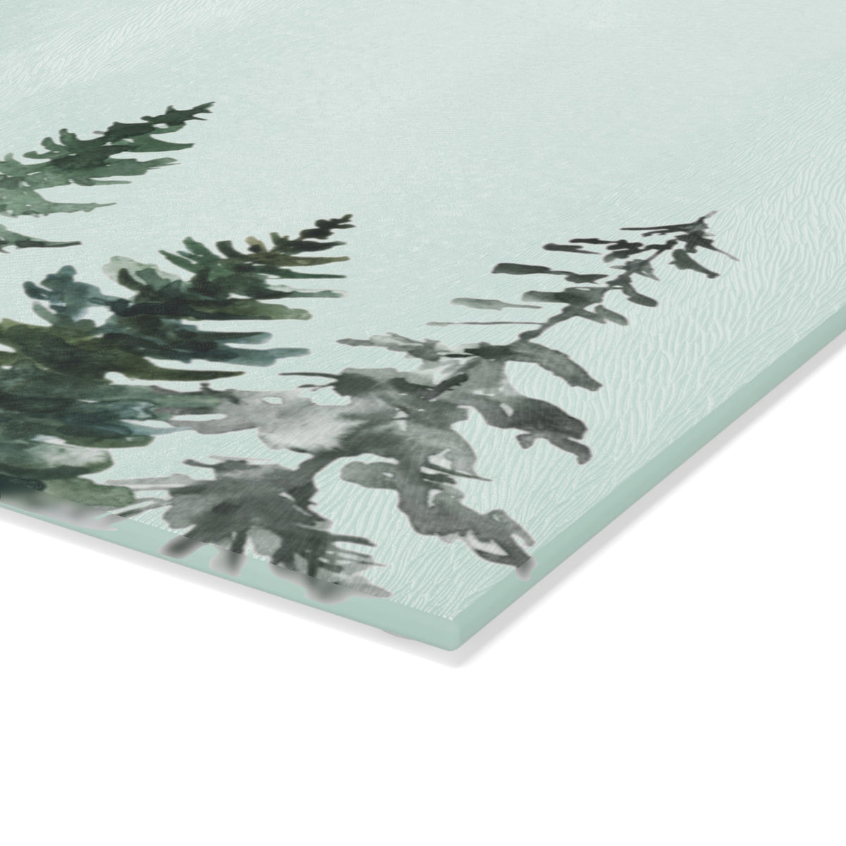 Green Christmas tree glass cutting board for holiday kitchen decor and food preparation.