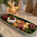 Emerald green and gold porcelain serving platter styled with festive appetizers for elegant Christmas entertaining.