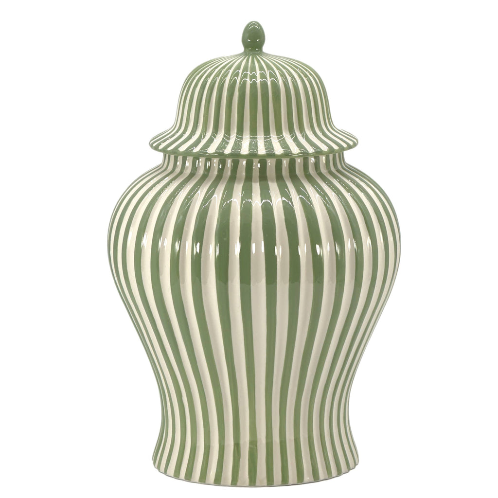 Close-up of the glossy green and white candy cane-inspired stripes on a ceramic decorative vase.