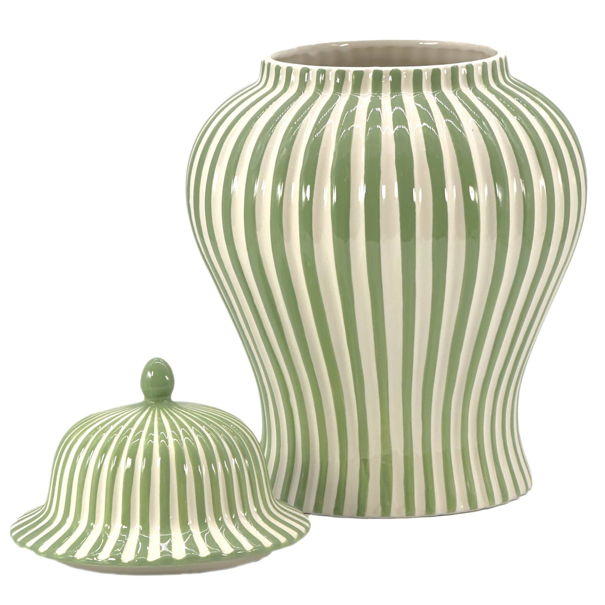 Green and white ceramic lidded vase styled in a classic cottage-inspired holiday interior.