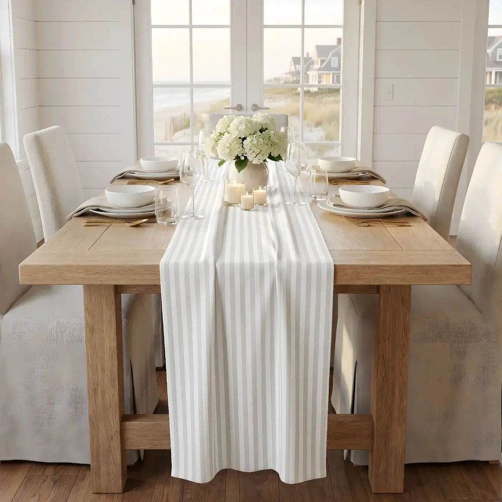 Gray and white striped table runner styled on a wood farmhouse table with glassware
