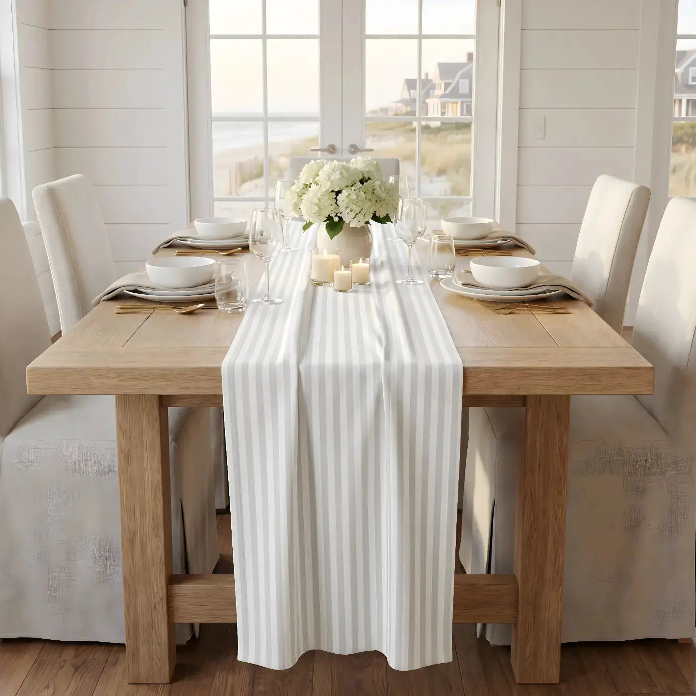 Gray and white striped table runner styled on a wood farmhouse table with glassware