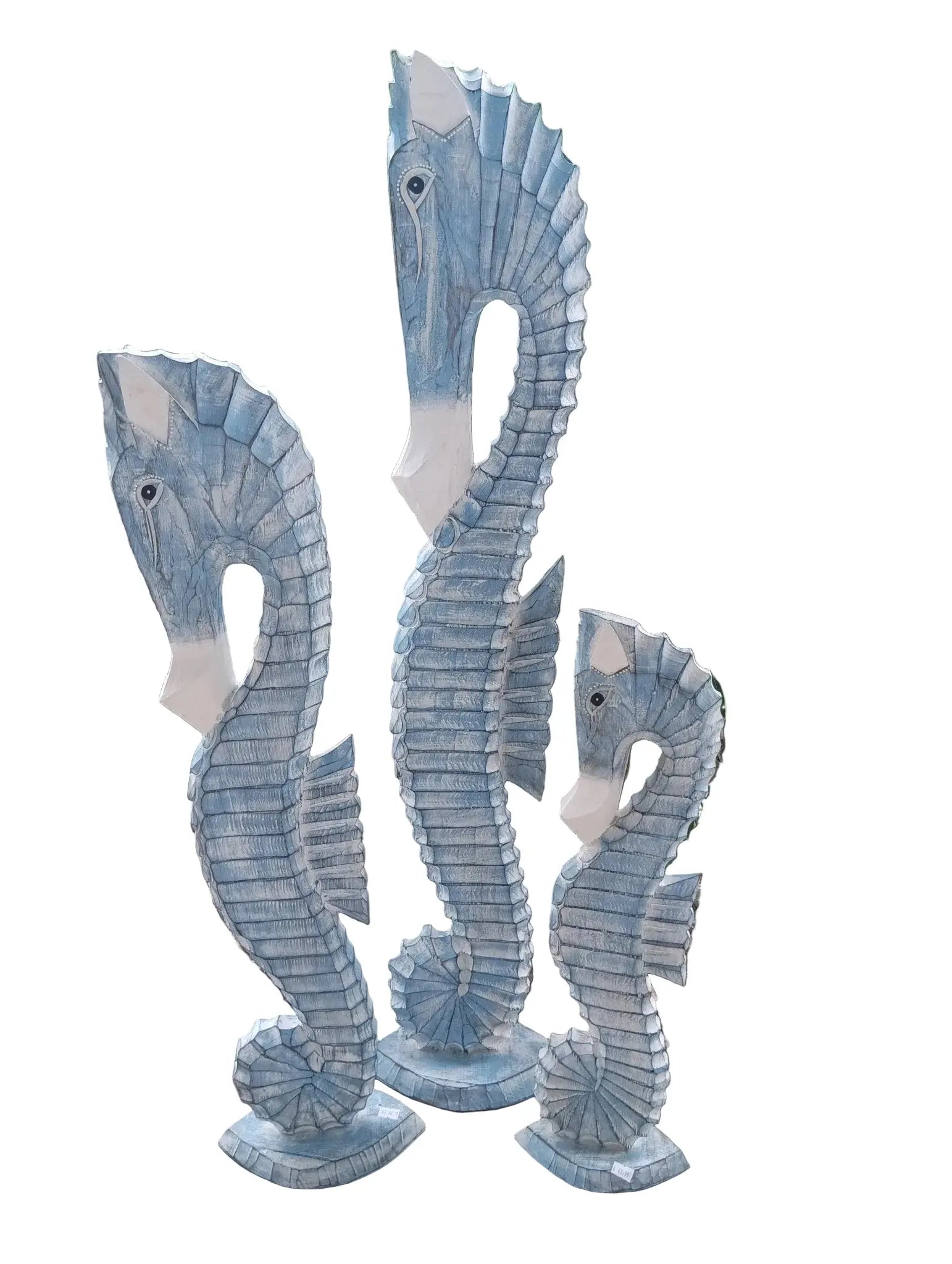 Three hand-carved coastal wood seahorses in ocean blue and teal tones.
