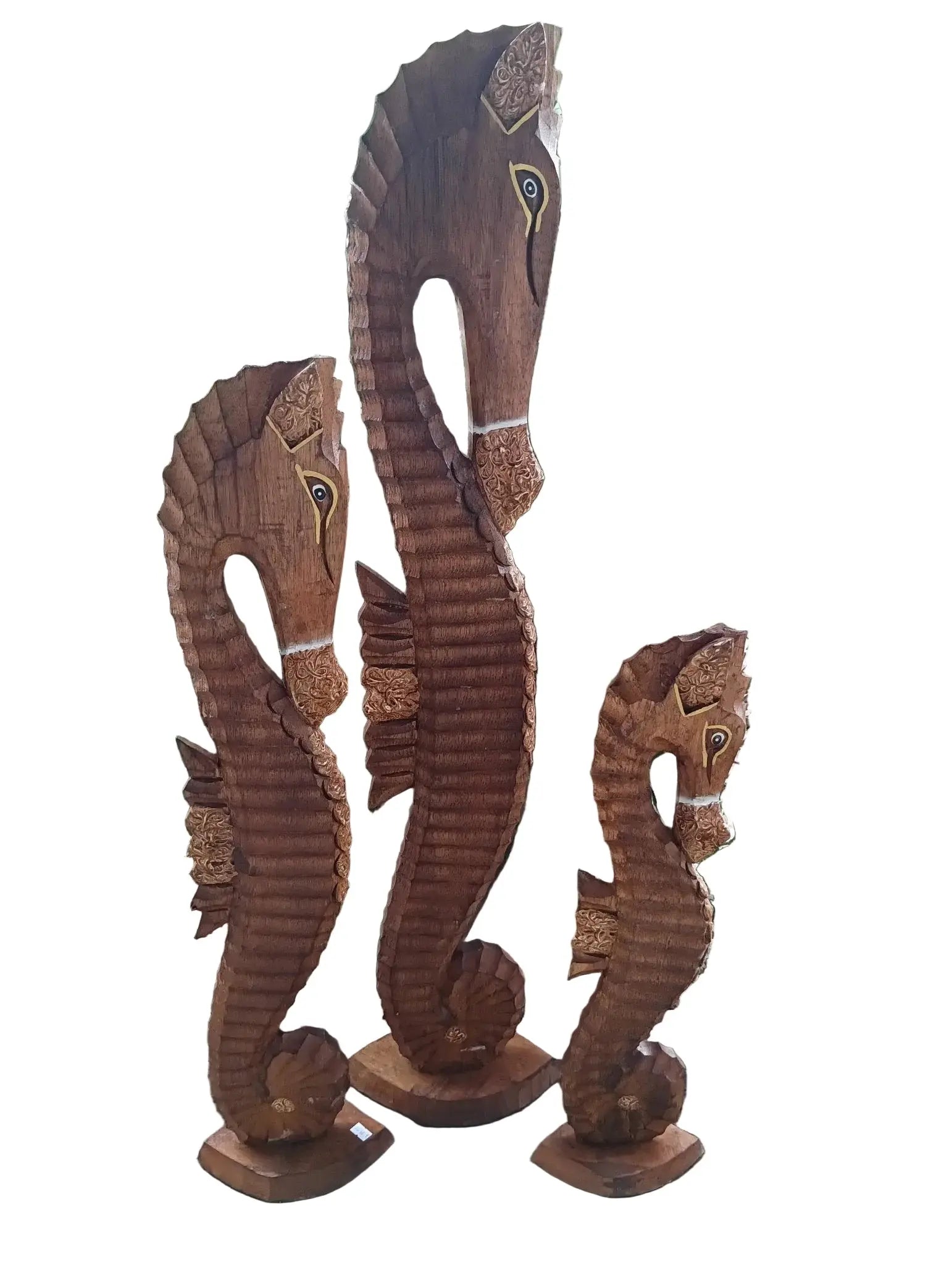 Three brown hand-carved seahorse wooden sculptures for coastal decor.