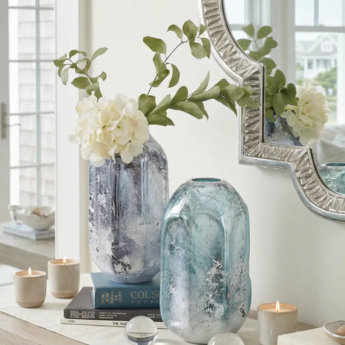 Modern blue glass decorative vase with striking blue hues and white detailing
