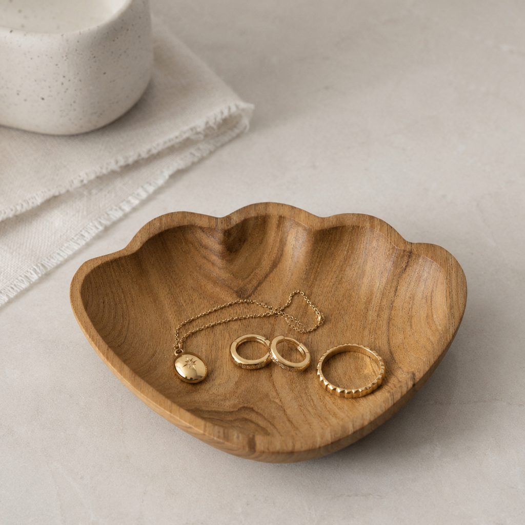 Decorative teak shell trinket dish styled for jewelry, keys, or small accessories.