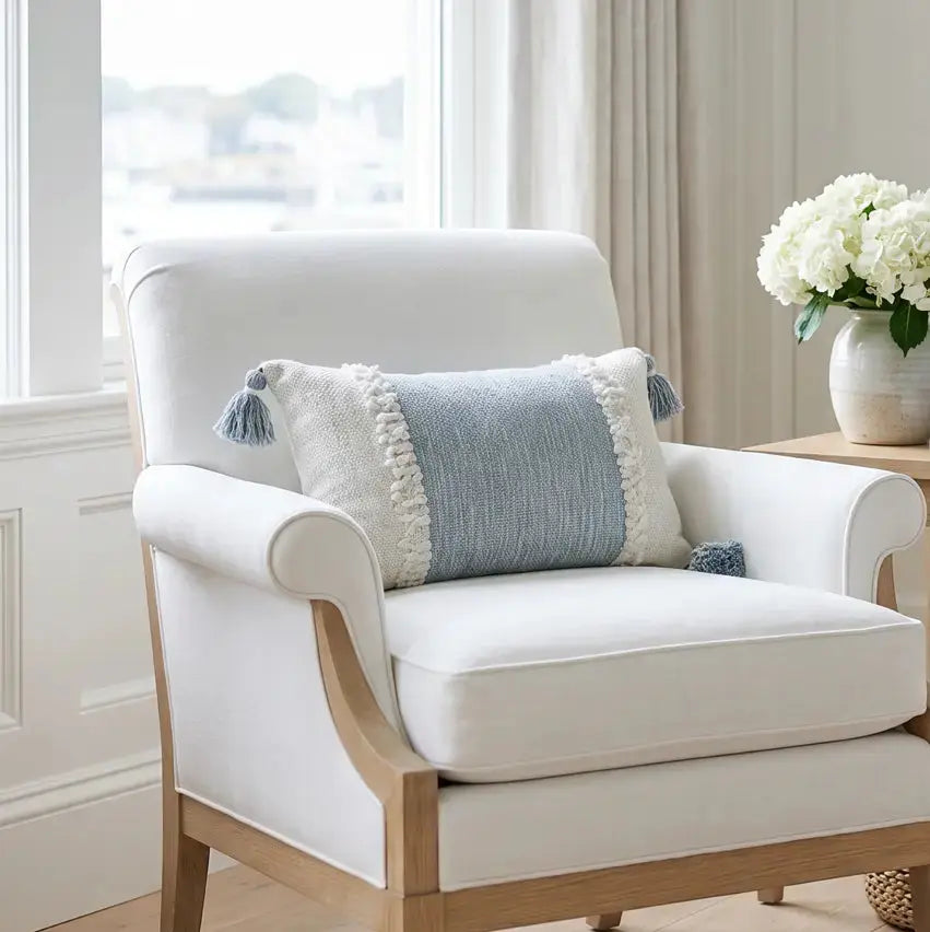 neutral textured pillow styled on sofa with layered decor