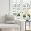 large 22x22 woven throw pillow with tassels on sofa