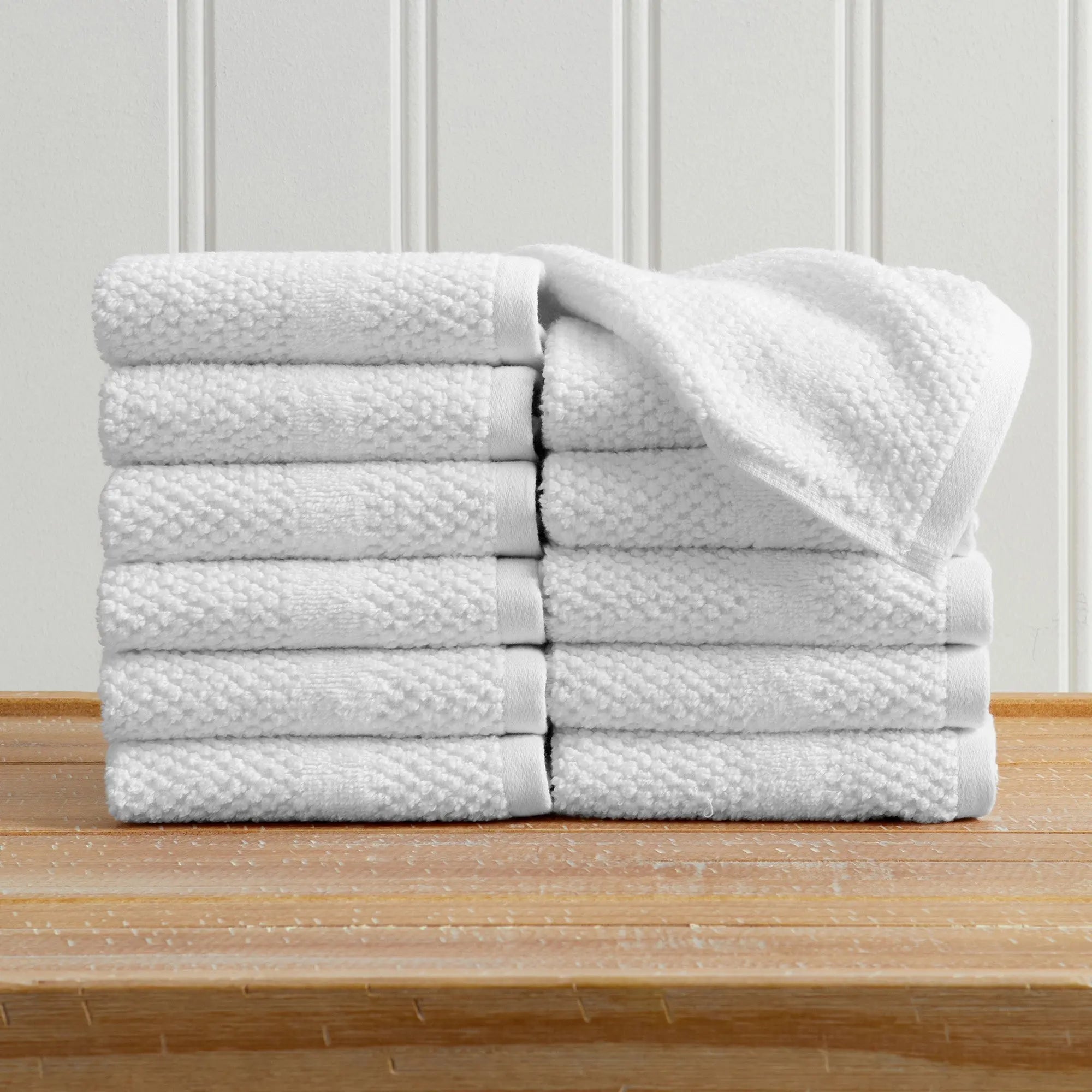 Bath towel set Marbella Collection by Great Bay Home; 100% cotton, white woven texture, stacked on wood