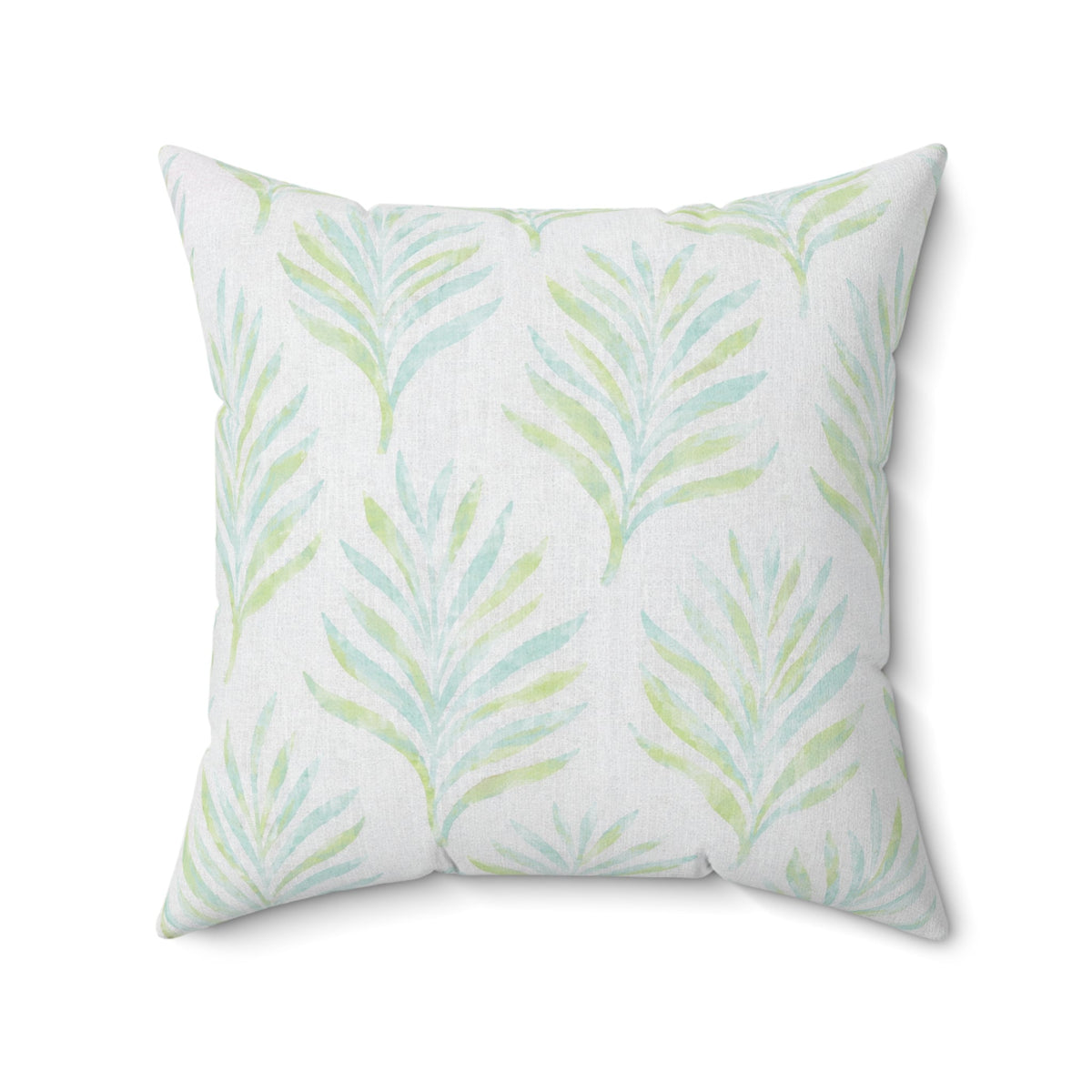 Ivory throw pillow with blue and green palm leaves in a coastal living room