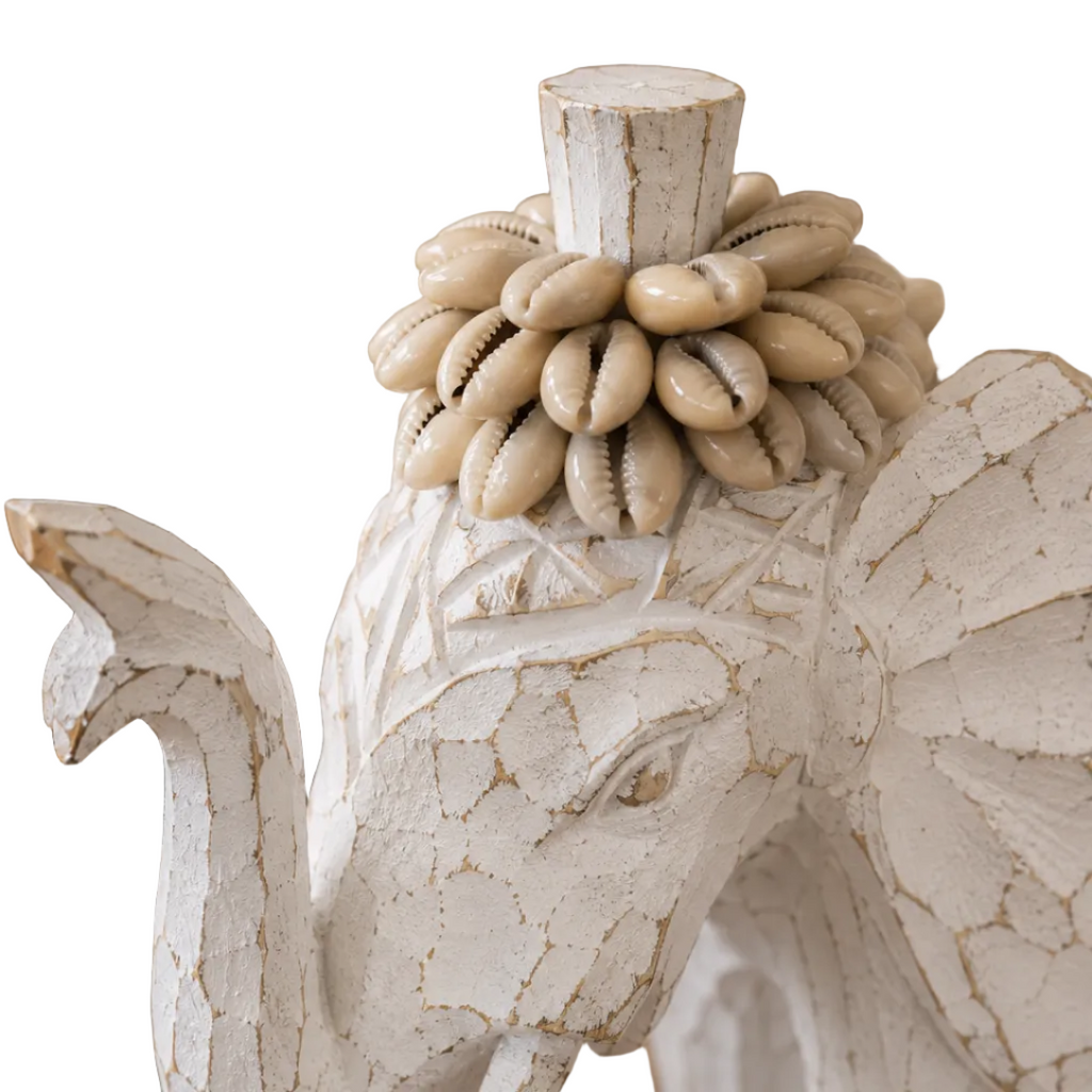 Close-up of the layered natural shell texture and artisan detailing on a decorative elephant sculpture.