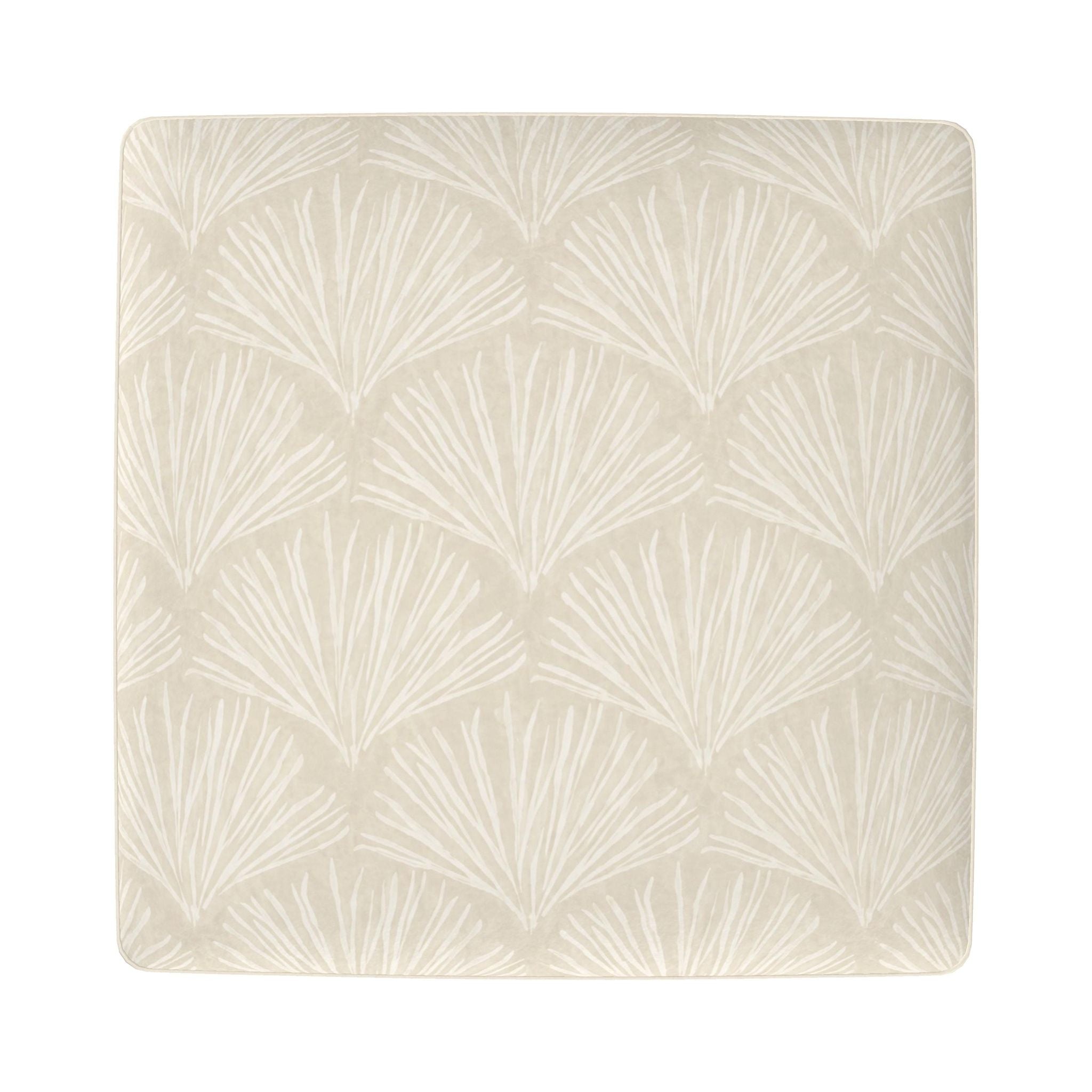 Ivory footstool featuring a subtle sea fan coral print on top and four light wood tapered legs.