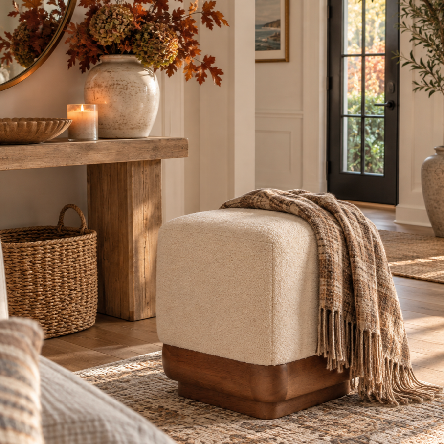 Ivory upholstered ottoman with a natural wood base for home decor