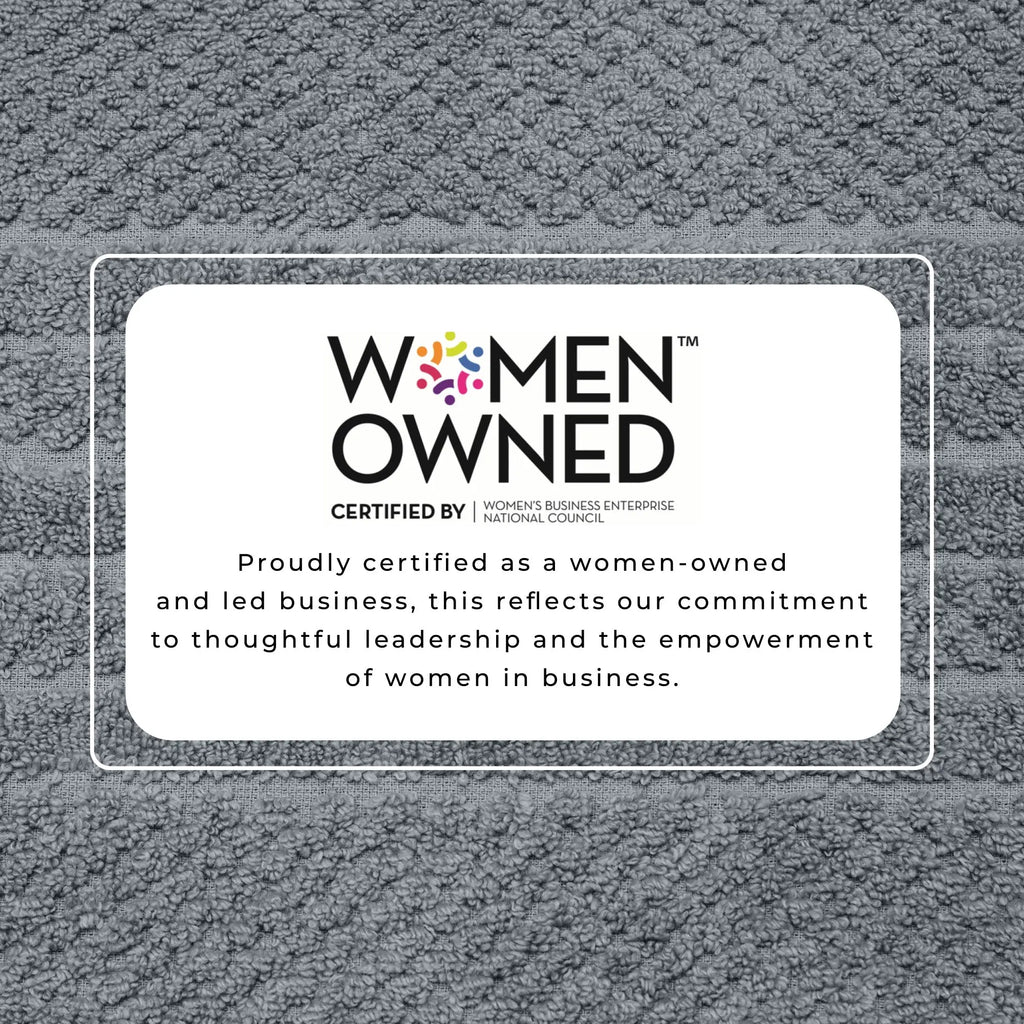 Bath towel set in gray cotton with Women Owned certification badge.
