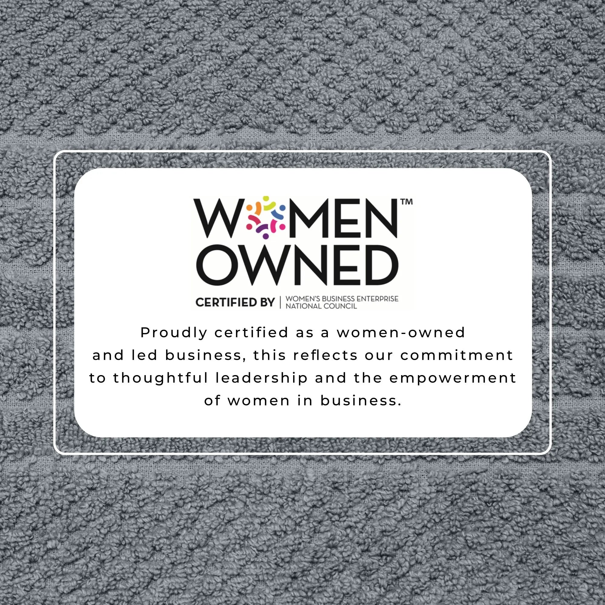 Bath towel set in gray cotton with Women Owned certification badge.