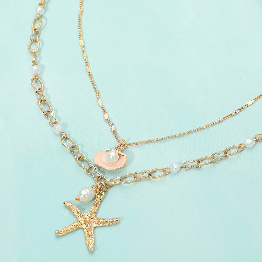 Layered gold seashell starfish necklace shown as beach inspired everyday jewelry.