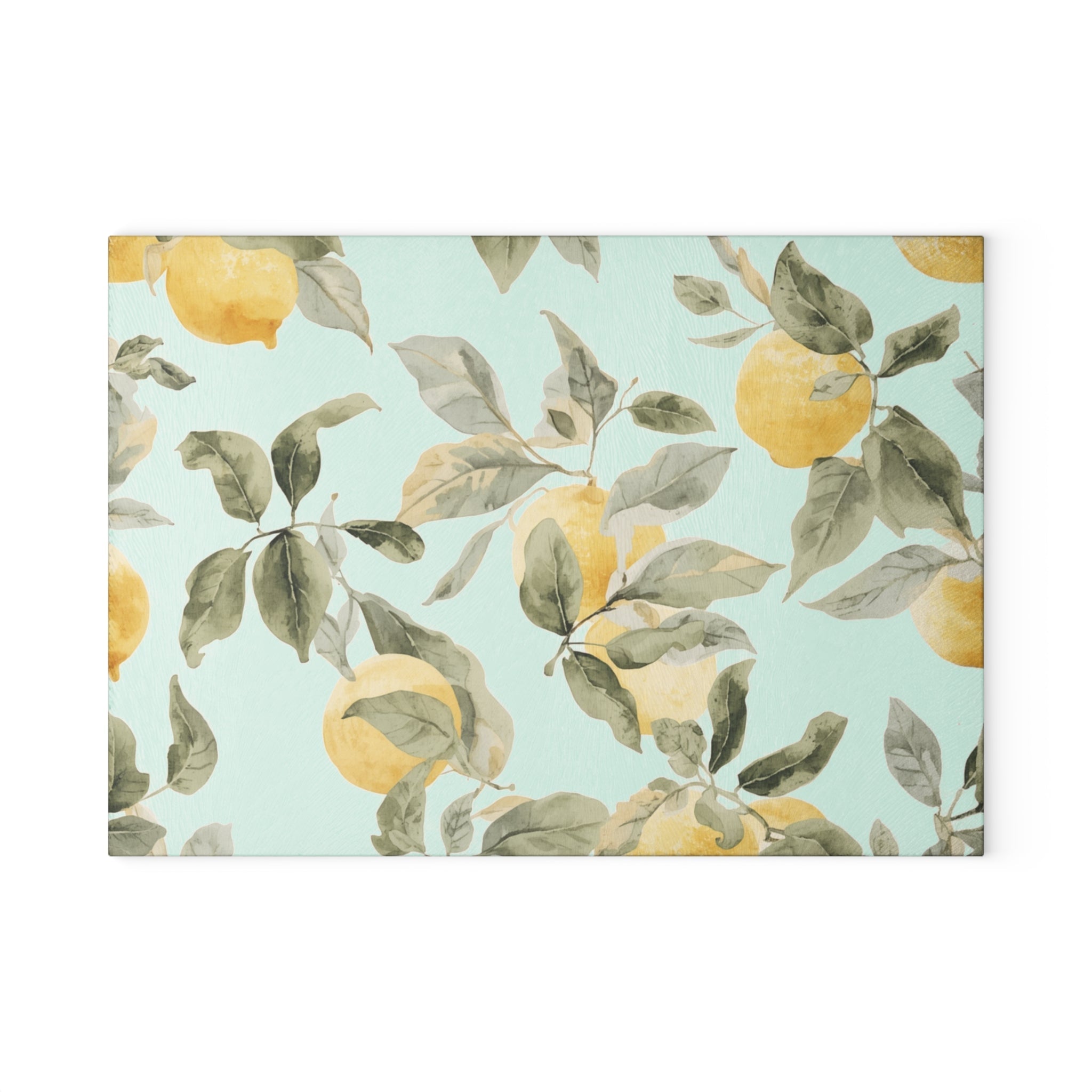 Rectangular tempered glass cutting board with lemon print styled in a bright coastal kitchen.
